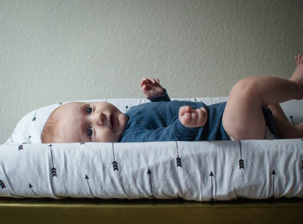 baby on diaper changing table