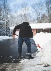 man is cleaning a snow