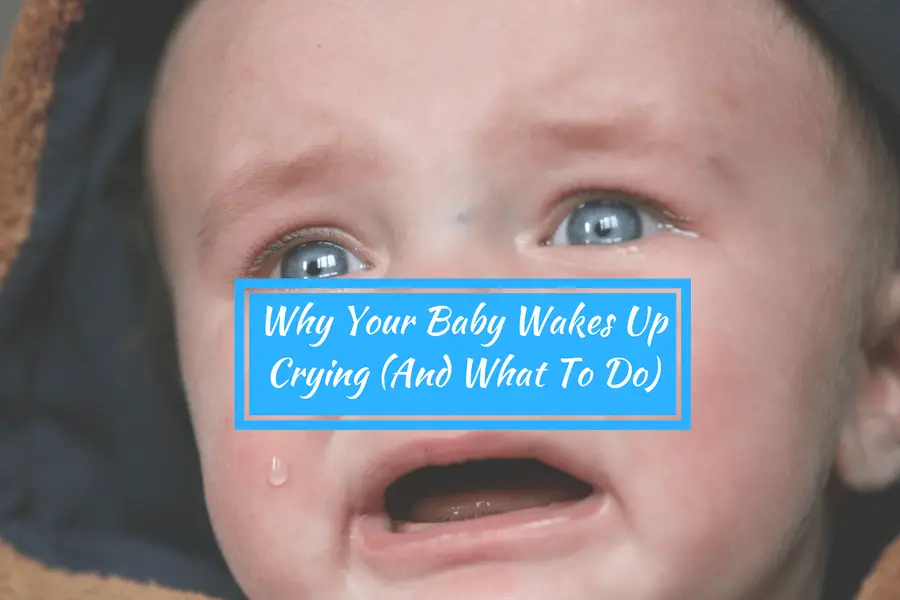 baby with blue eyes is crying and has sad face