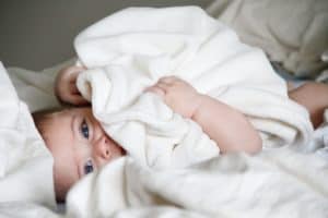 baby holding blanket