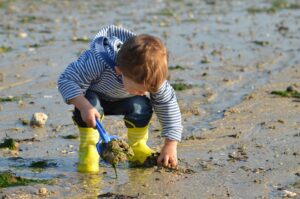 kid playing on sand