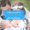 bride is breastfeeding her baby and the groom is looking at the baby