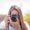 A woman taking a photo with a DSLR camera